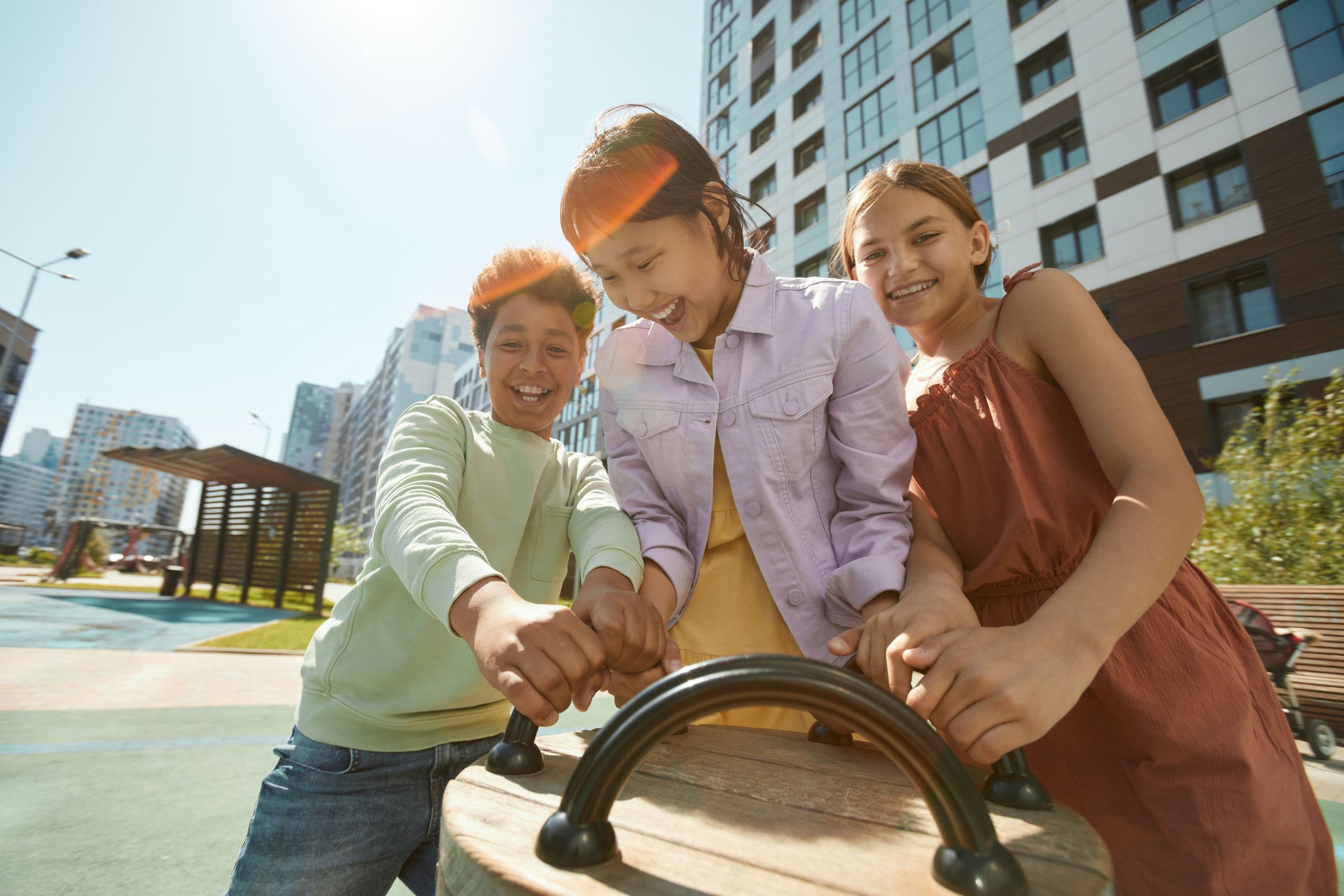 A group of newcomer youth playing together at an outdoor park.