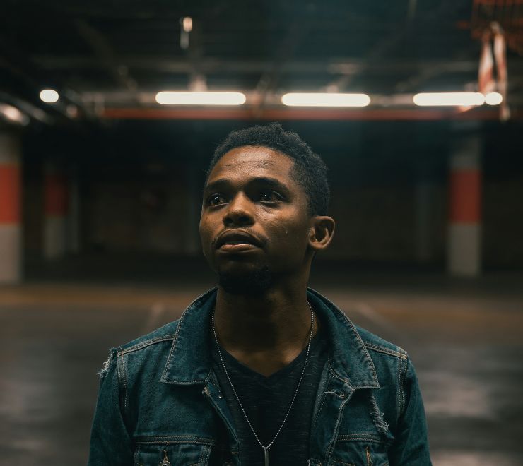 An image of a Black young person in a parking lot on a Kids Help Phone webpage