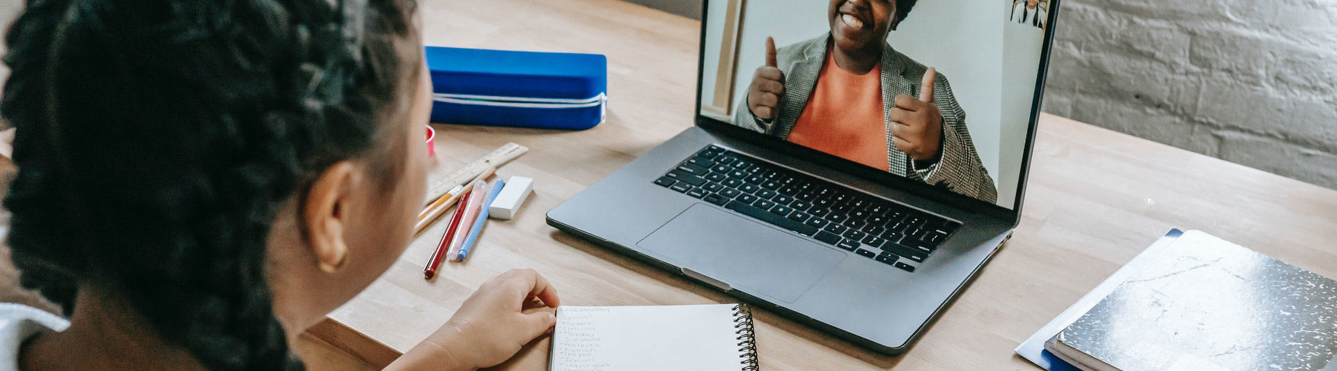 A young person on a video call at a desk