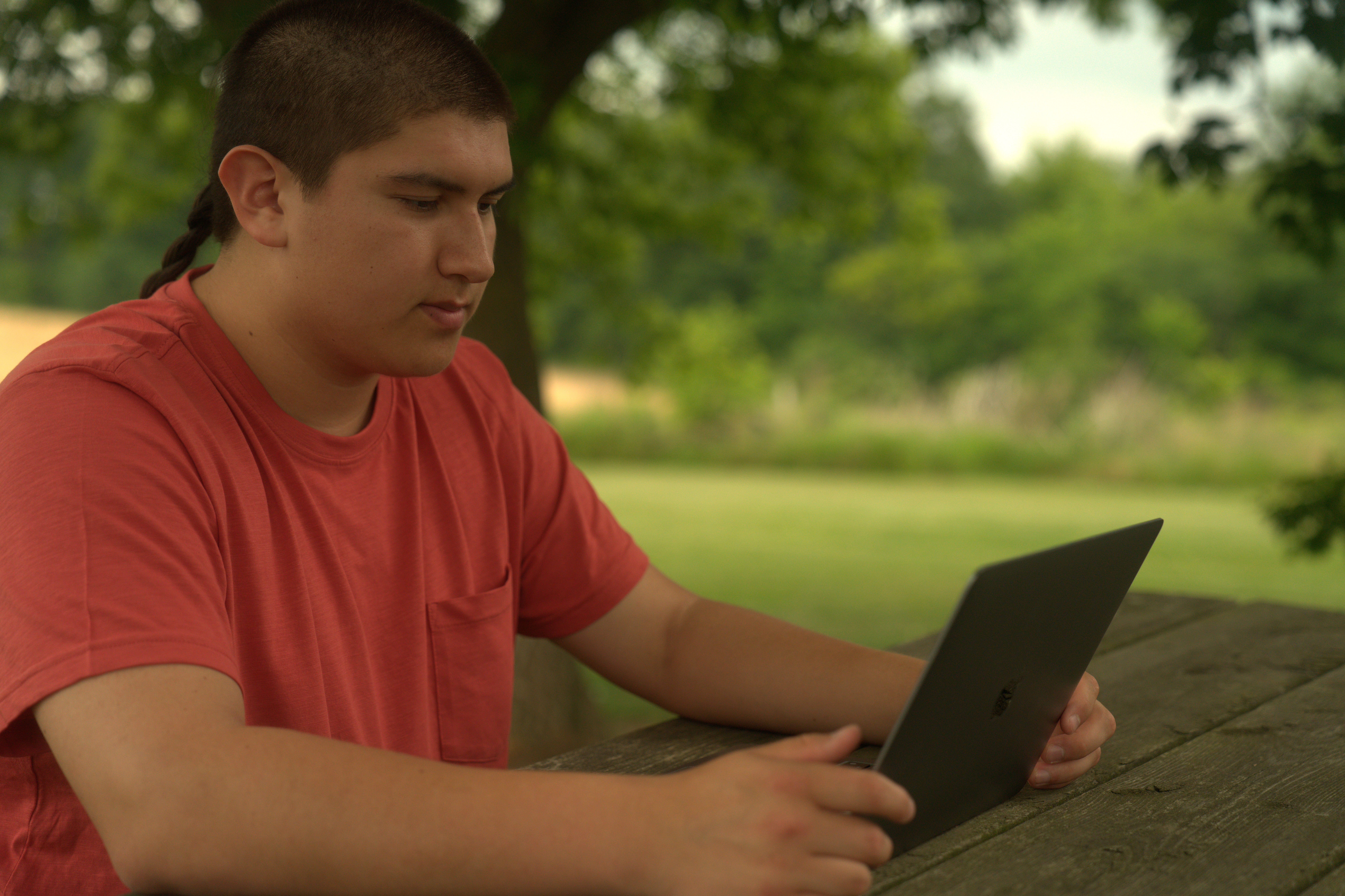 An Indigenous young person using a tablet to explore KHP’s peer-to-peer community.