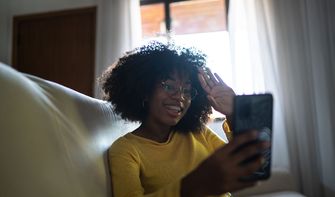 Community creator using a smartphone to record a video of themselves